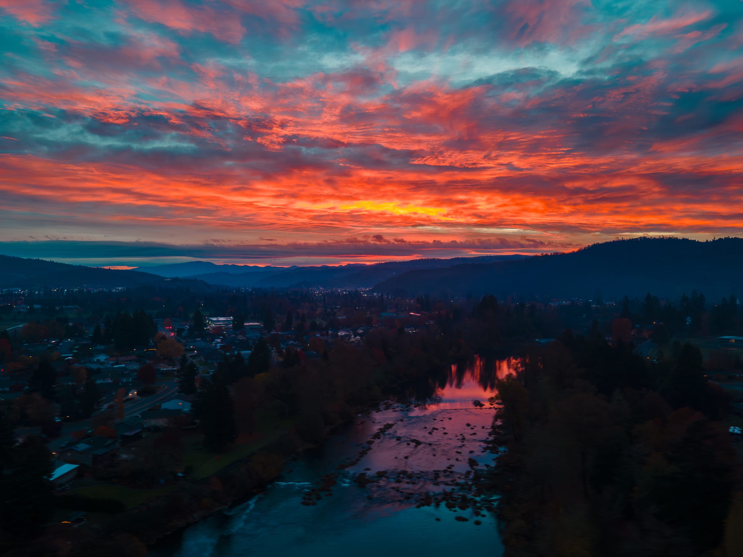 A red and orange November sunrise over the South Umpqua River as it runs through Roseburg